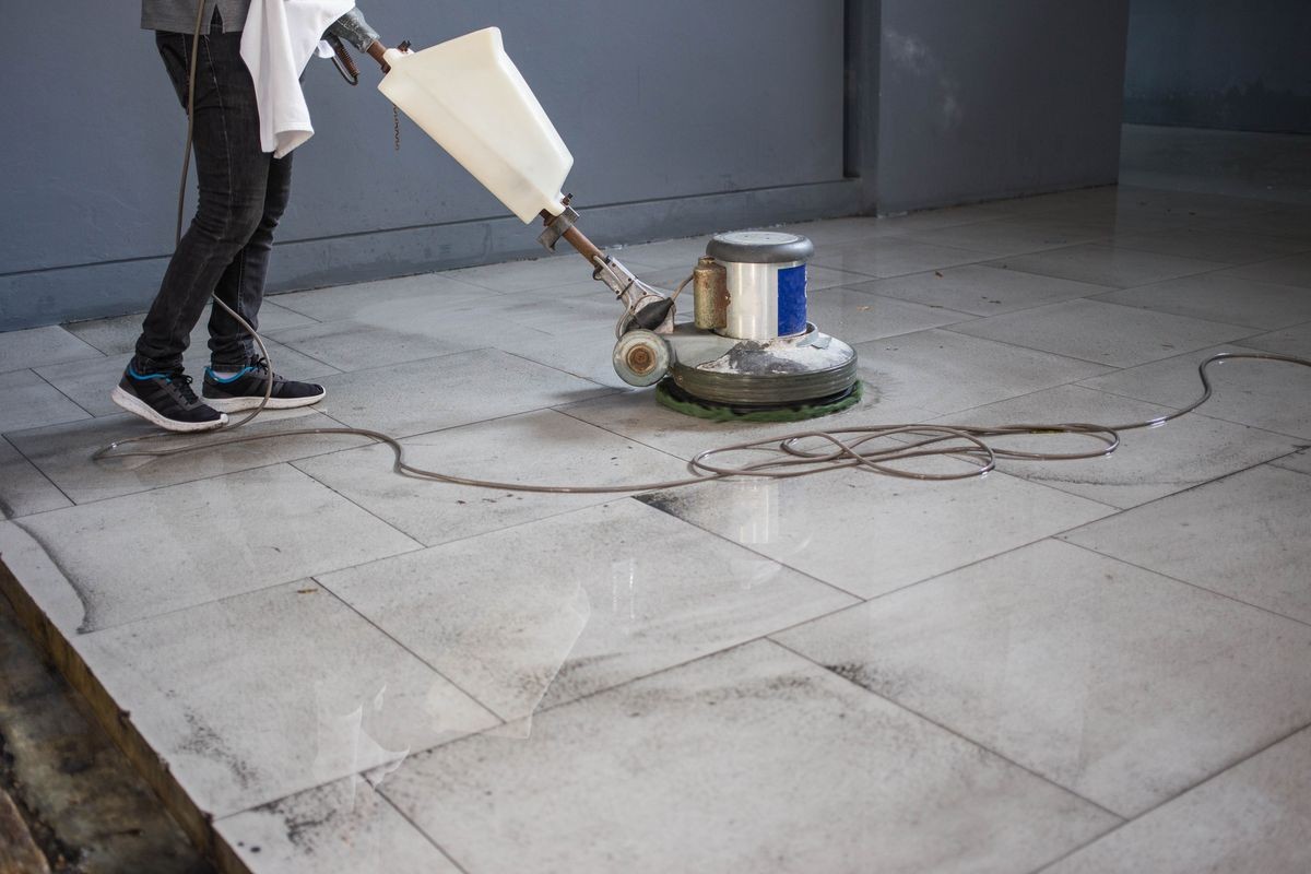 The people cleaning floor with machine. The people cleaning floor with machine.